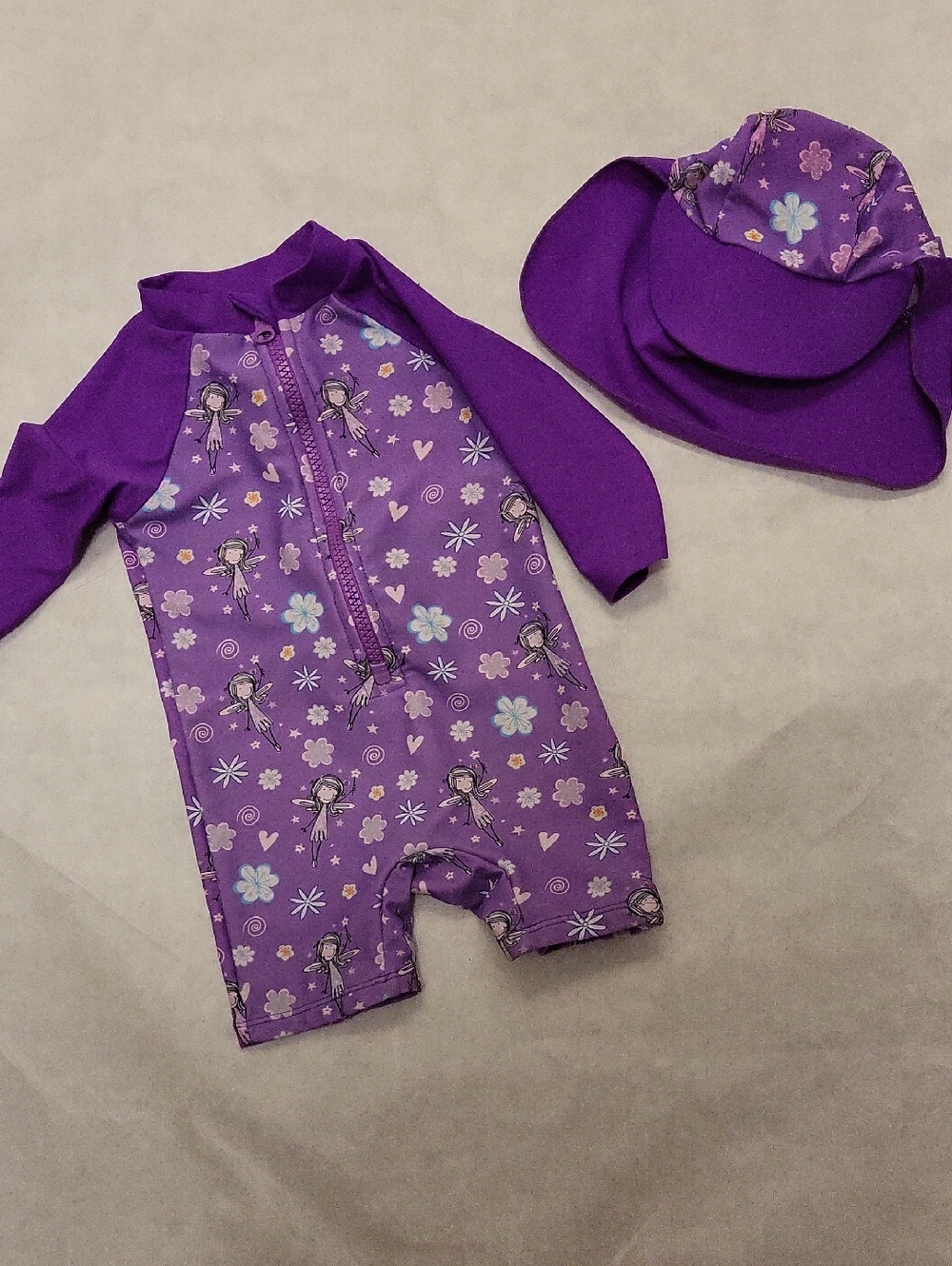 Purple rashguard swimsuit with matching sun hat